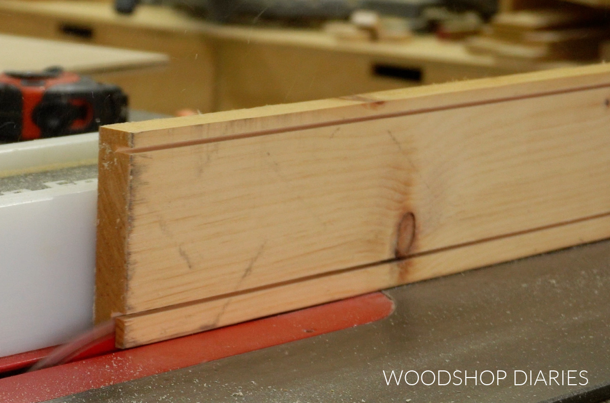 Close up of cutting groove out of shadow box board on table saw