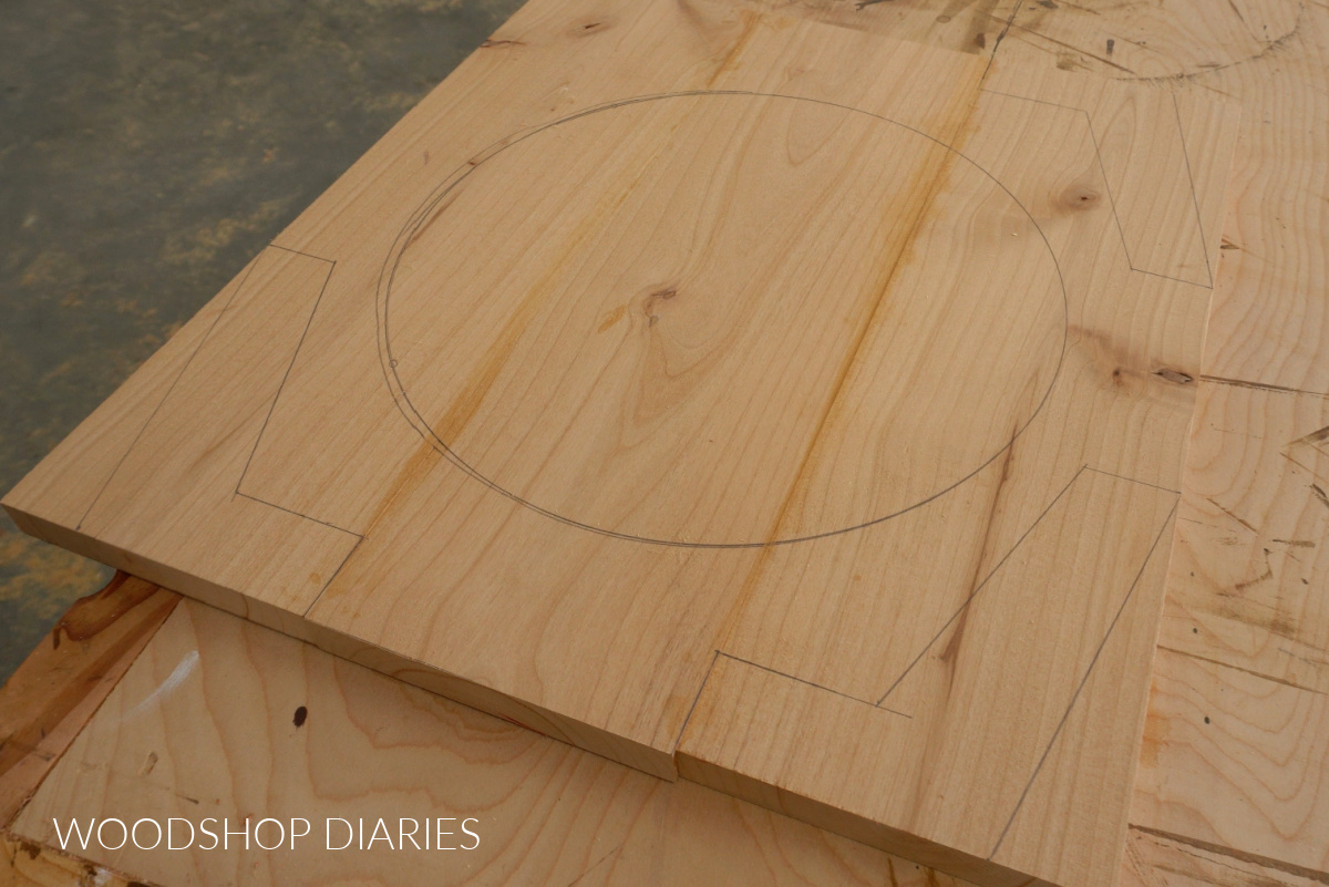Glued up wood panel with circle traced in center and three modern legs traced on corners