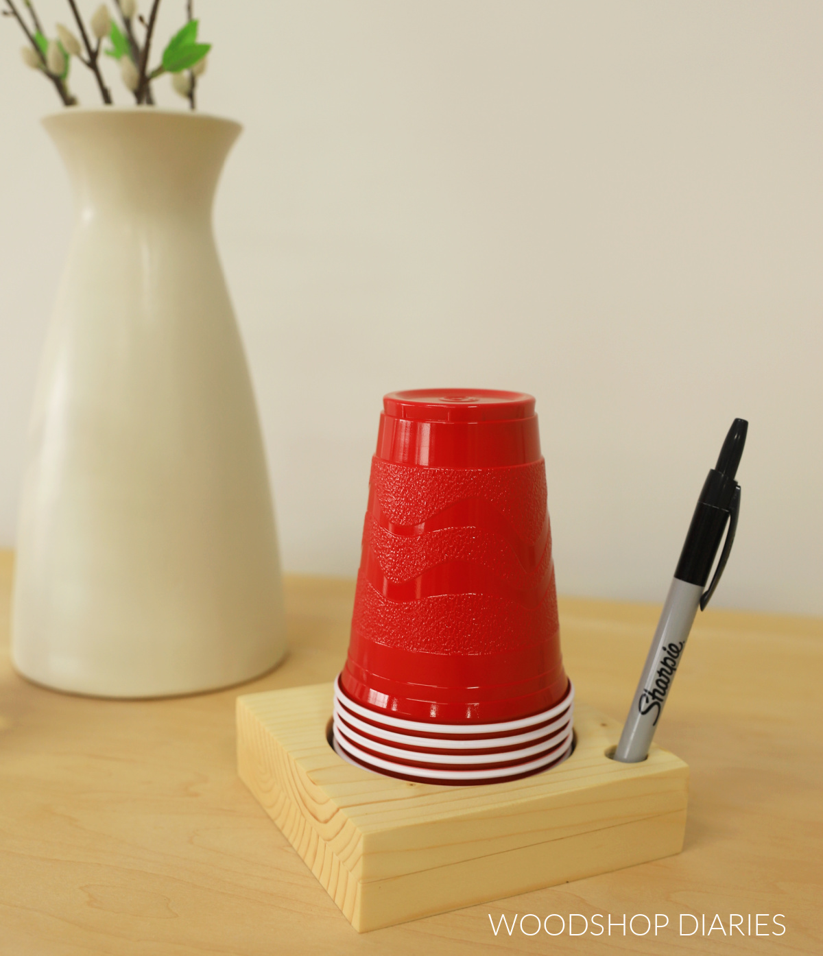 Completed wooden DIY cup holder with marker