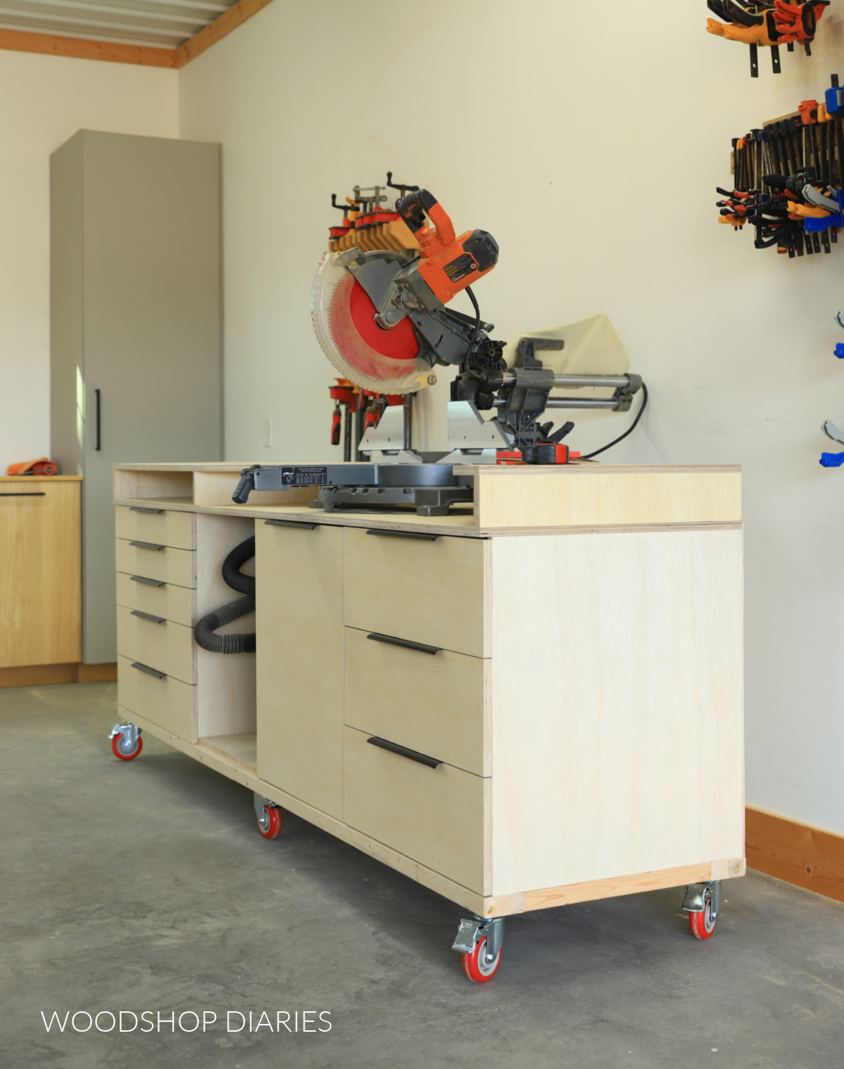Mobile miter saw stand with storage in workshop