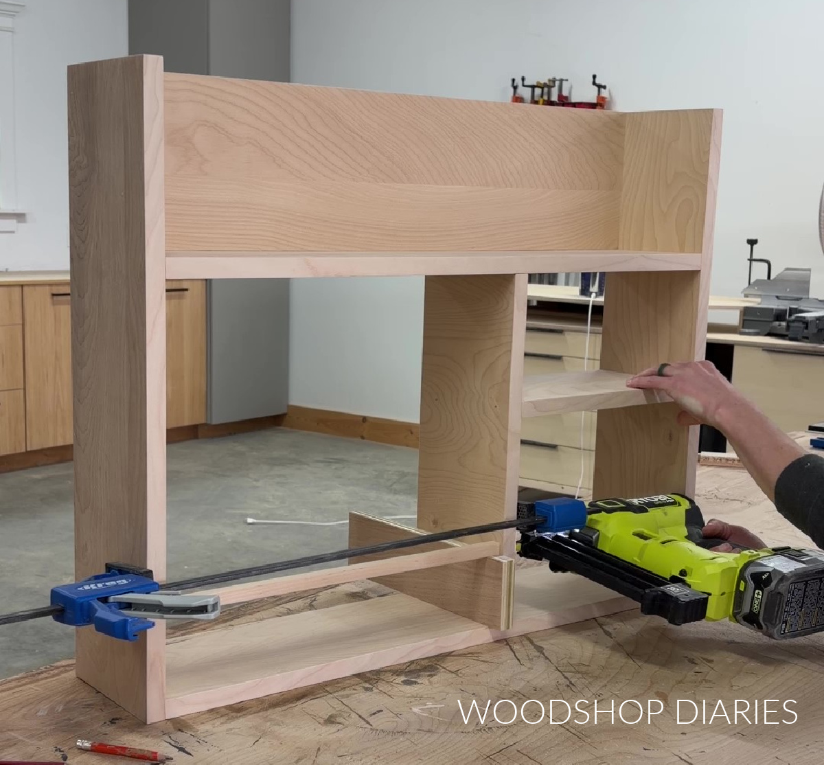 Using brad nailer to install divider pieces in Murphy desk frame