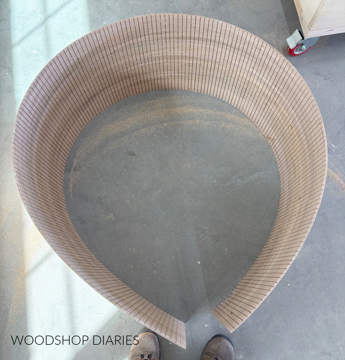 Strip of ¼" plywood with ⅛" deep kerf cuts every ½" so it bends