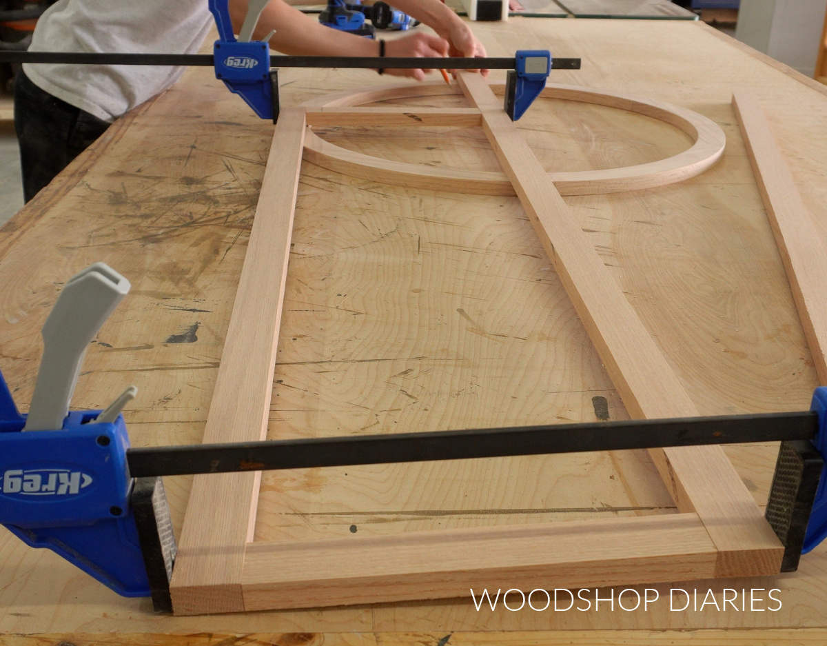 Shara Woodshop Diaries marking where to cut wooden circle to make arched door frames